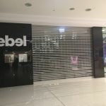 rebel storefront with roller shutter door